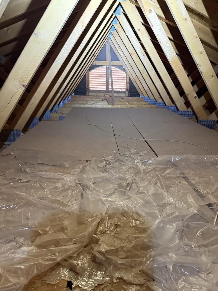 Attic with bare decking and no insulation before Arizona Attic Pros installation